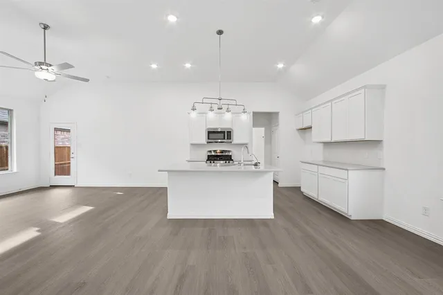 a view of kitchen with sink microwave and refrigerator