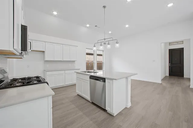 a kitchen with stainless steel appliances granite countertop a stove and a sink