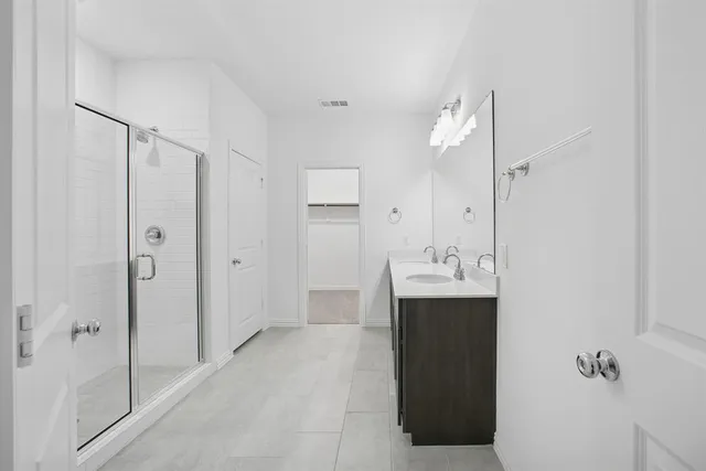 a view of bathroom with a sink and mirror