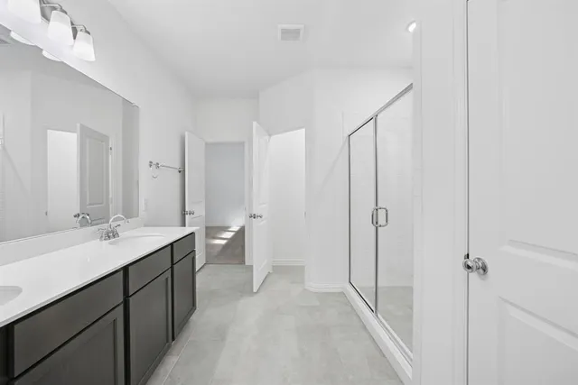 a bathroom with a double vanity sink toilet mirror and bathtub