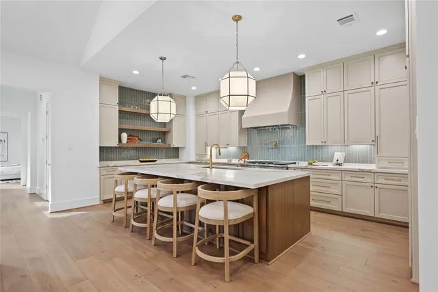 a large kitchen with a table and chairs in it