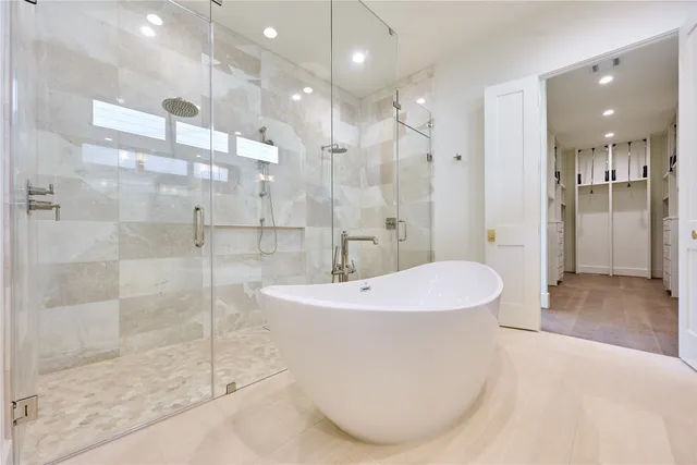 a bathroom with a bathtub and shower