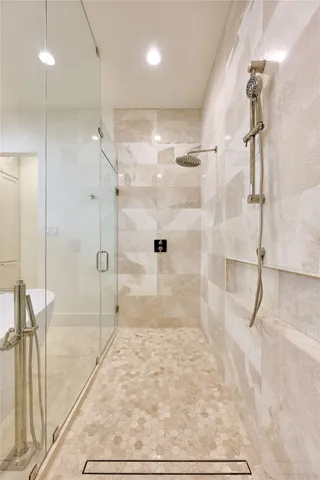 a bathroom with a glass shower door