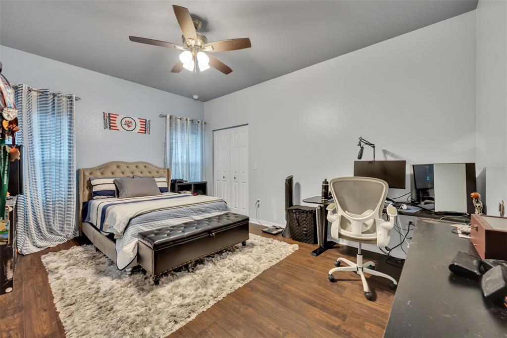 4946 Northeast 124th Road Oxford, FL 34484 - Photo 37 of 69 a bedroom with a bed a desk and chair
