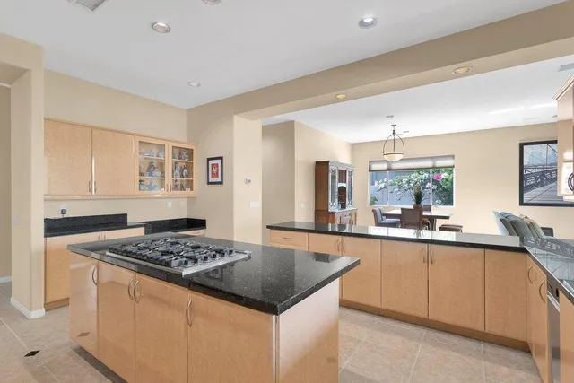 a kitchen with a stove a sink a refrigerator and wooden cabinets