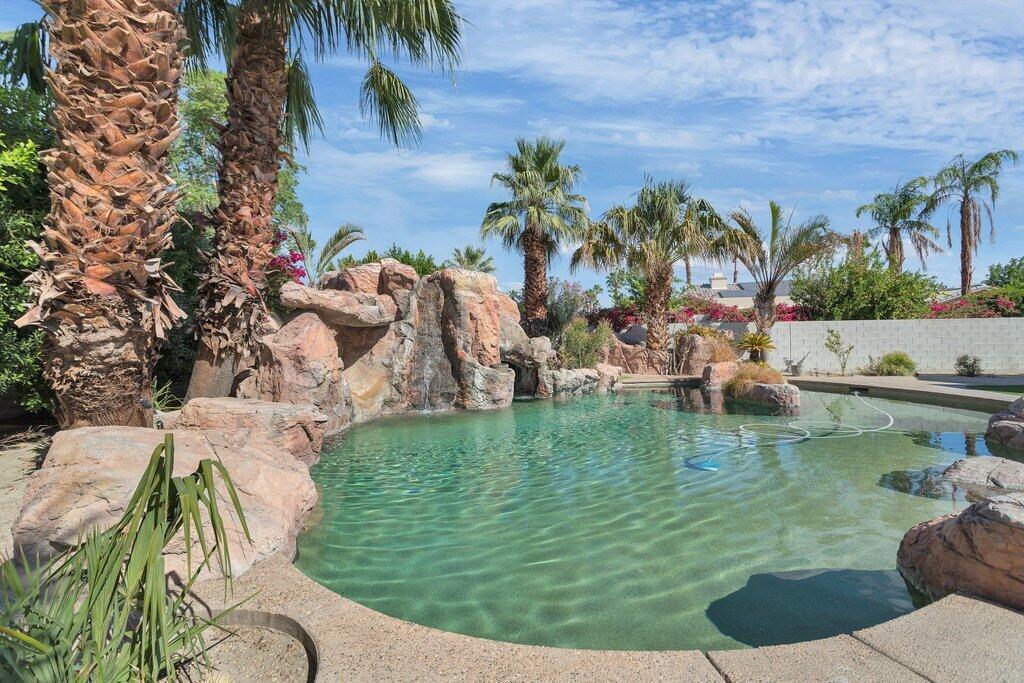 8 MacBeth Court Rancho Mirage, CA 92270 - Photo 2 of 46 a view of swimming pool with a garden and seating area