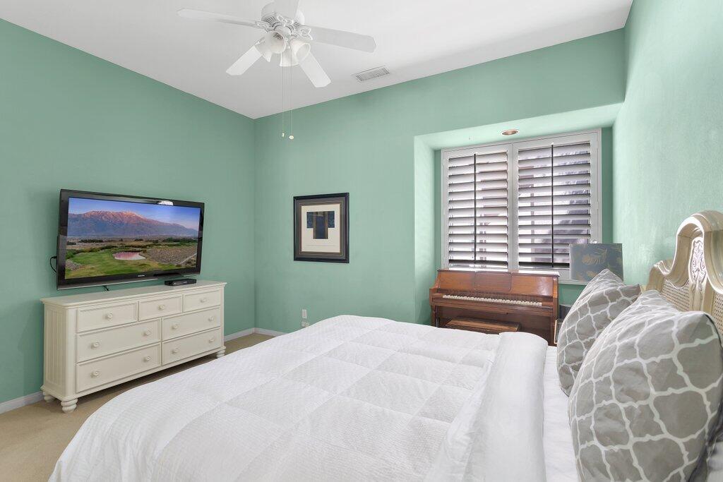 8 MacBeth Court Rancho Mirage, CA 92270 - Photo 26 of 46 a bedroom with a bed and a flat screen tv