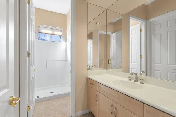 a bathroom with a double vanity sink and a mirror