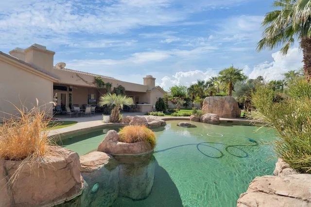 a view of a backyard with furniture and a fire pit