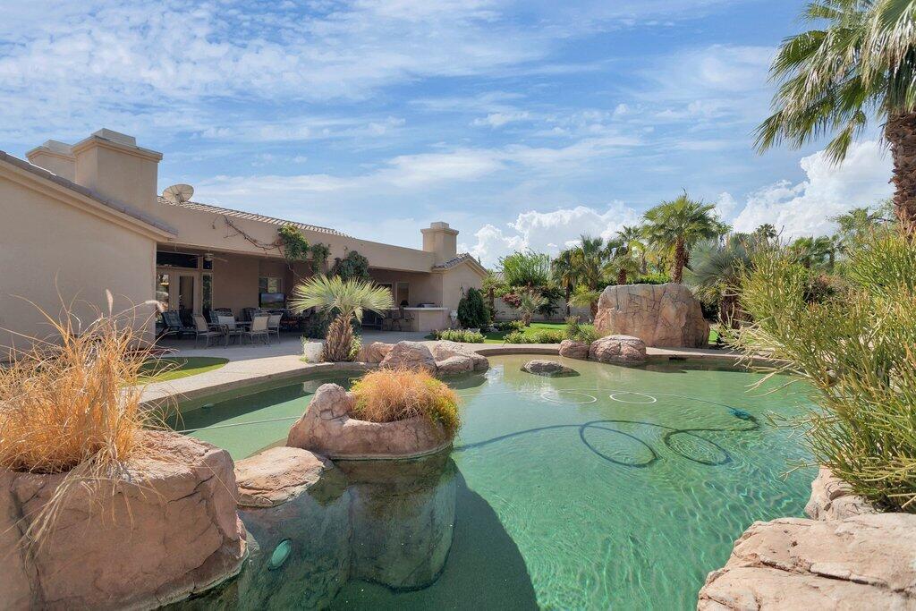 8 MacBeth Court Rancho Mirage, CA 92270 - Photo 36 of 46 a view of a backyard with furniture and a fire pit