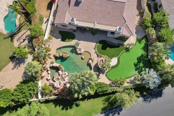 an aerial view of a house with a yard and lake view