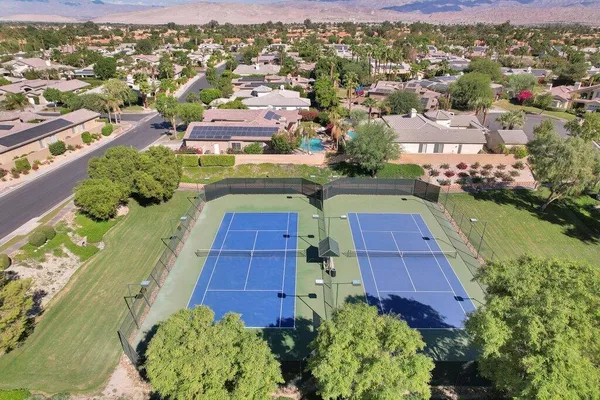 an aerial view of a house with a yard and garden
