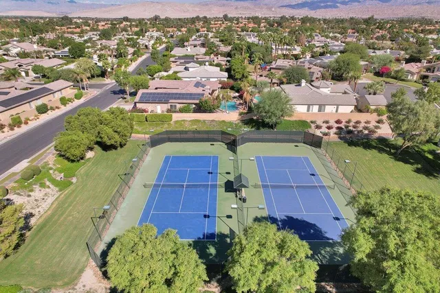 an aerial view of a house with a yard and garden
