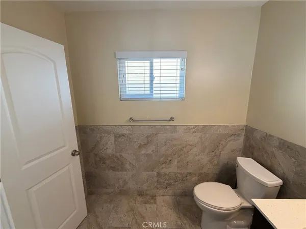 a white toilet sitting next to a window