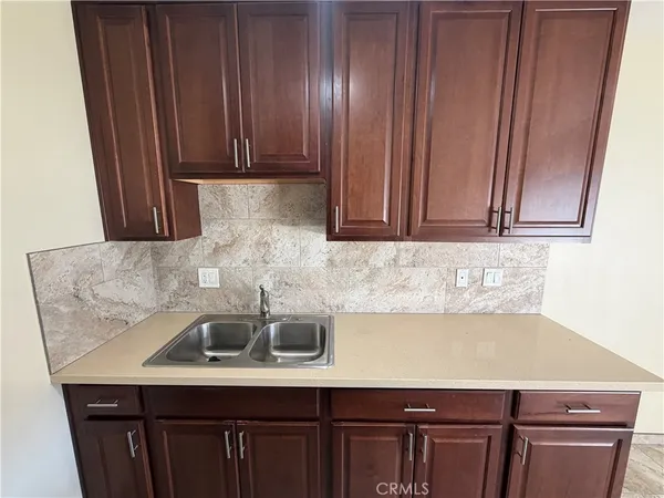 a kitchen with a sink and cabinets