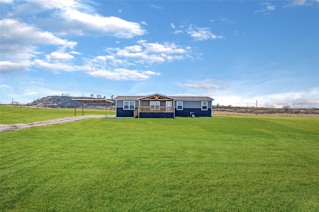 1023 Hopewell Road Bowie, TX 76230 - Photo 2 of 28 a view of a garden with lawn chairs