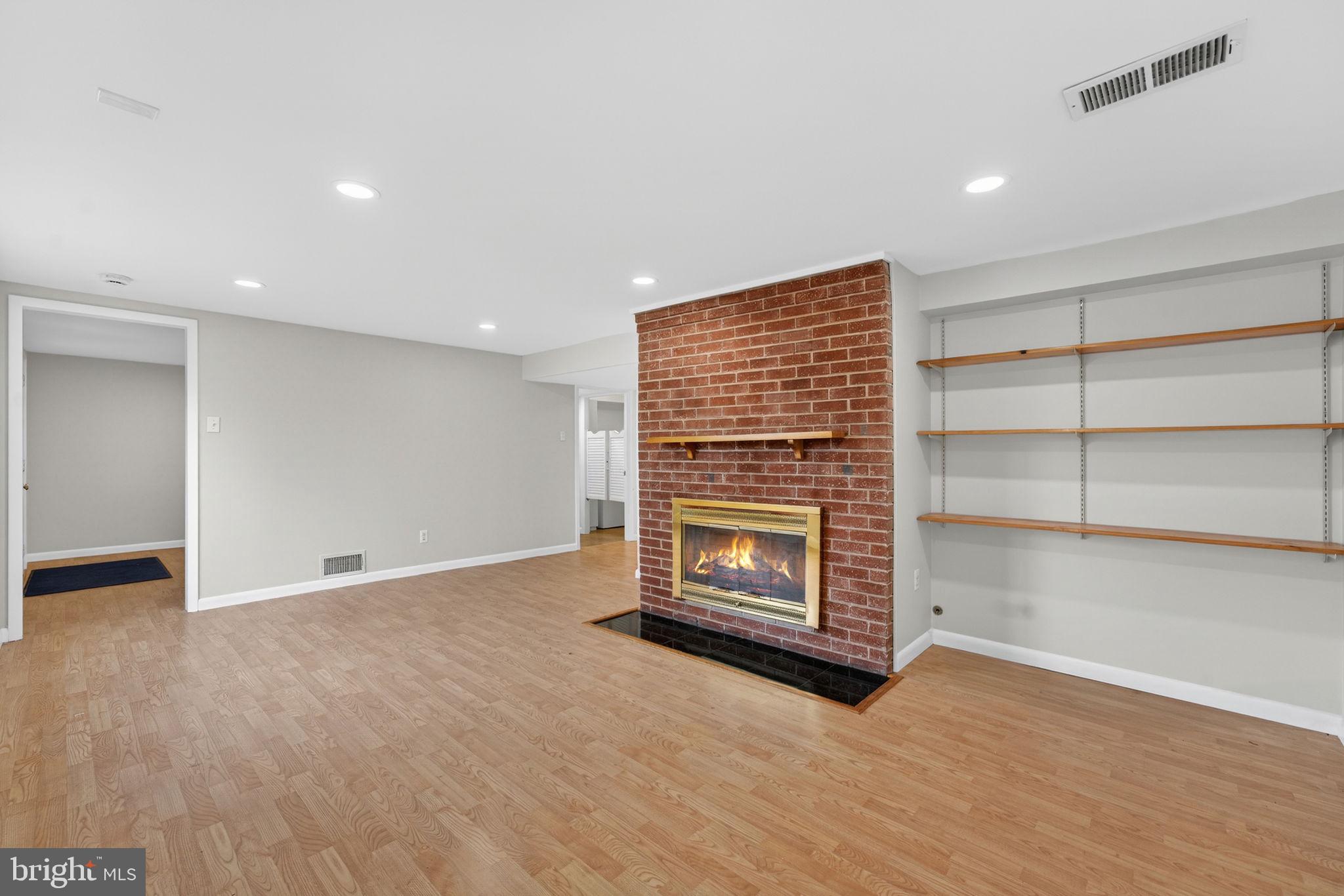 7507 Murillo Street Springfield, VA 22151 - Photo 12 of 44 a view of an empty room with a fireplace and a window