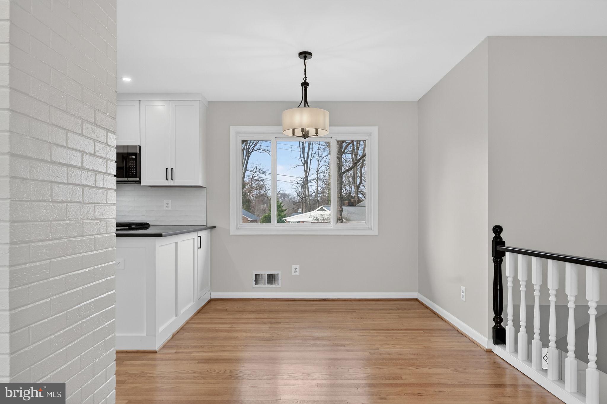 7507 Murillo Street Springfield, VA 22151 - Photo 19 of 44 a kitchen with stainless steel appliances granite countertop a stove a sink and a window