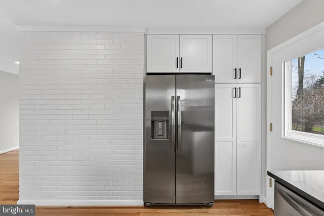 a kitchen with a refrigerator and a stove top oven