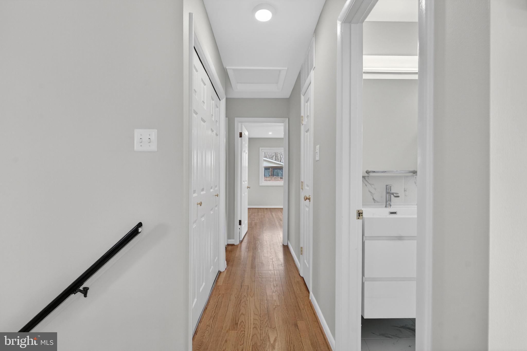 7507 Murillo Street Springfield, VA 22151 - Photo 25 of 44 a view of a hallway with a wooden door