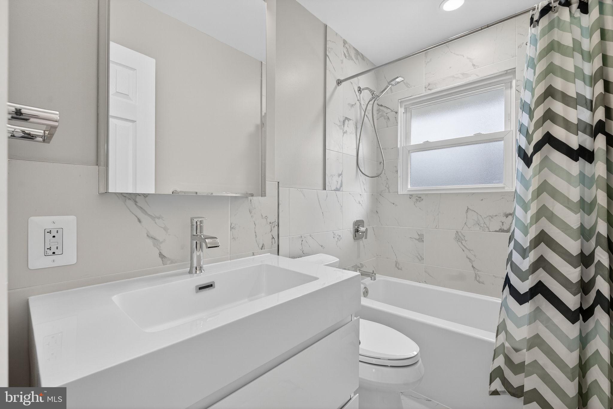 7507 Murillo Street Springfield, VA 22151 - Photo 26 of 44 a bathroom with a sink a toilet and a bathtub