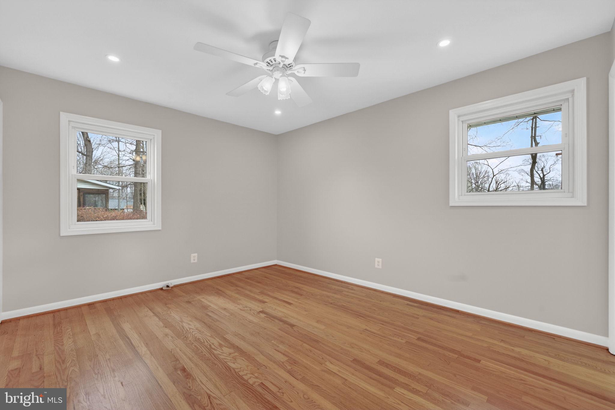 7507 Murillo Street Springfield, VA 22151 - Photo 28 of 44 a view of an empty room with wooden floor and a ceiling fan