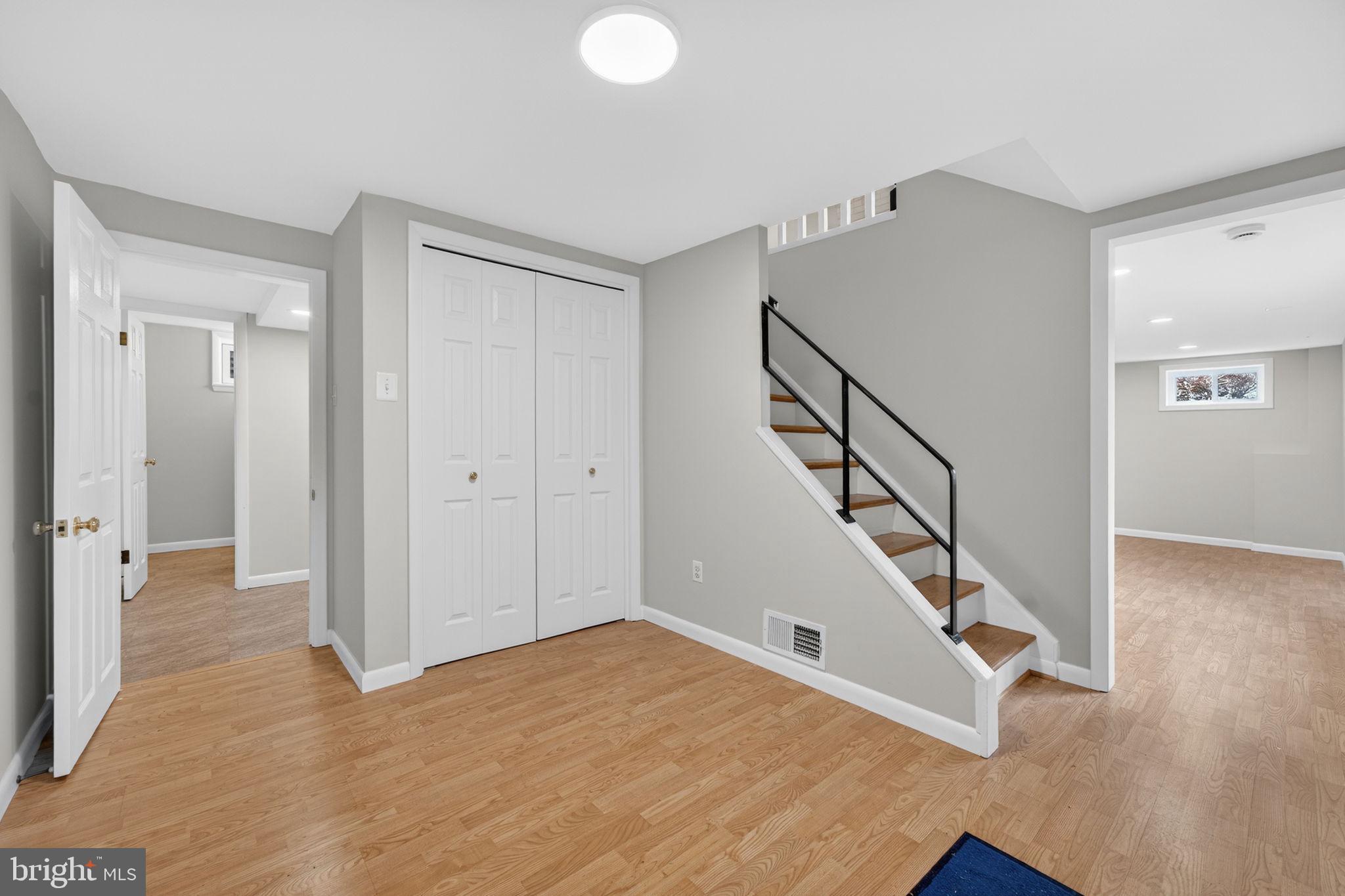 7507 Murillo Street Springfield, VA 22151 - Photo 3 of 44 a view of a hallway with staircase and white walls