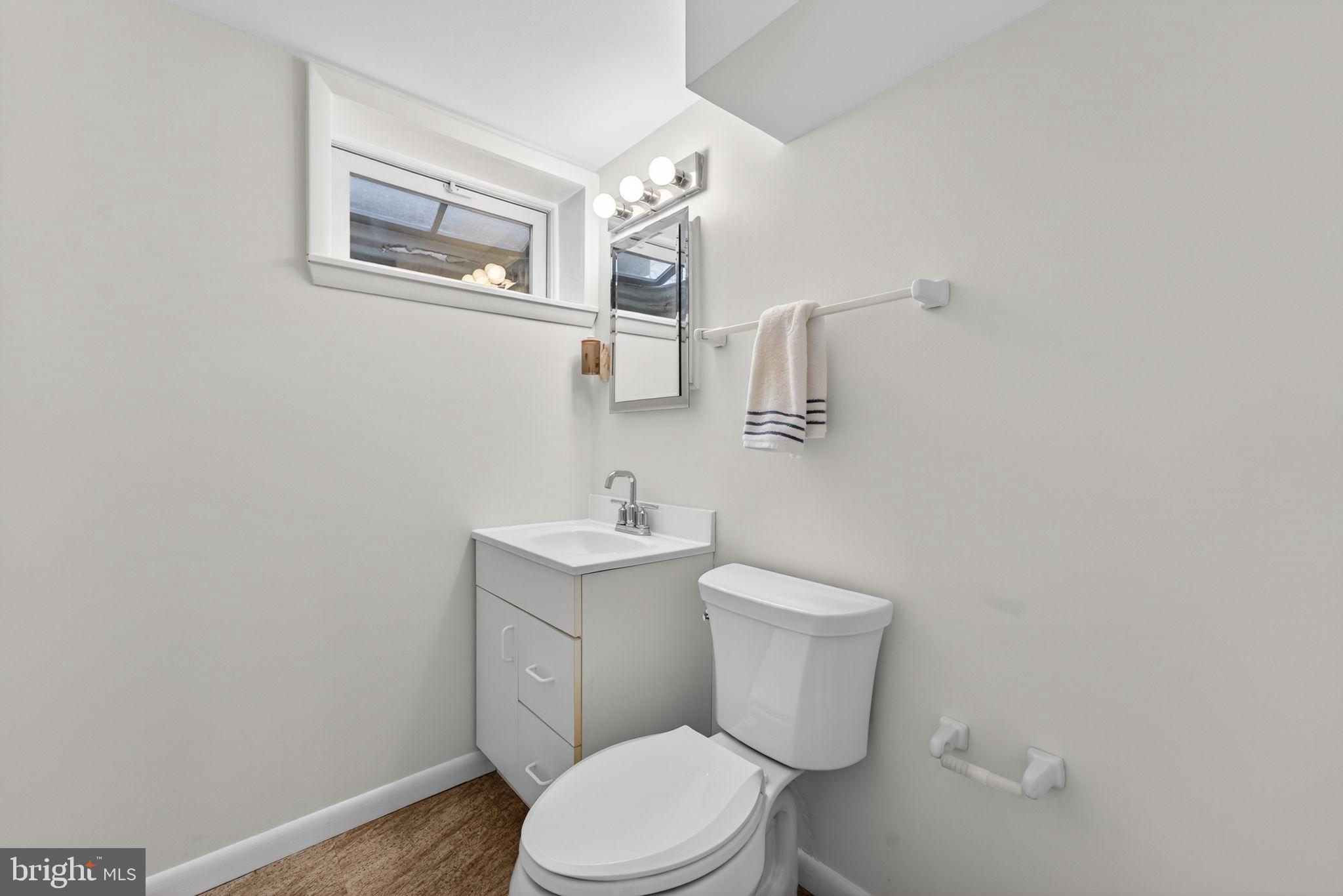 7507 Murillo Street Springfield, VA 22151 - Photo 5 of 44 a white toilet sitting next to a bathroom sink