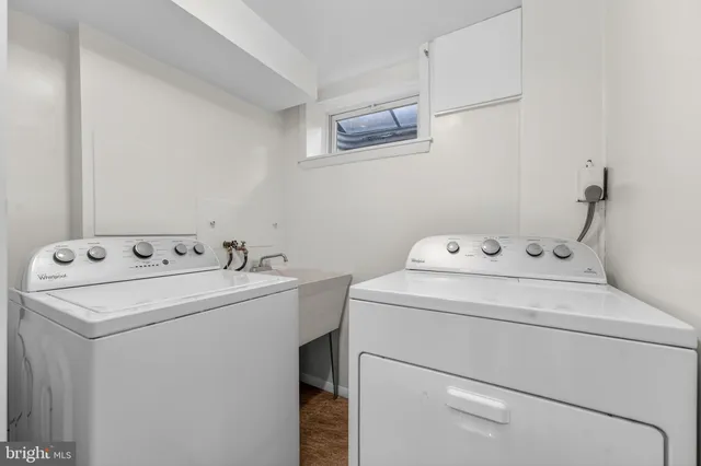 a white toilet sitting next to a bathroom sink