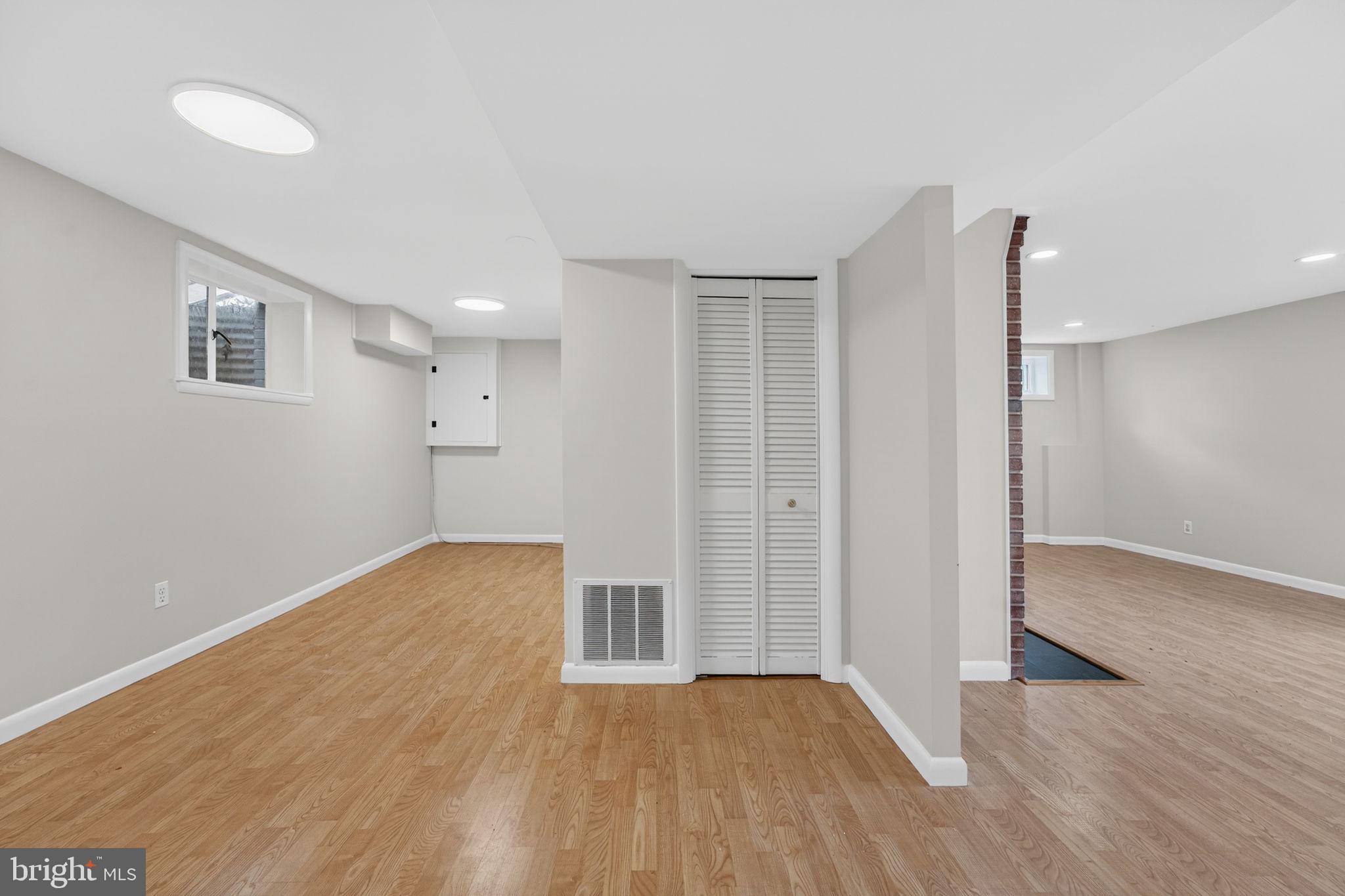 7507 Murillo Street Springfield, VA 22151 - Photo 8 of 44 a view of an empty room with wooden floor and a window