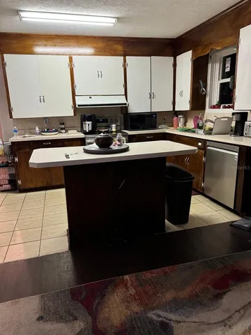 a kitchen with a sink and a stove next to a window