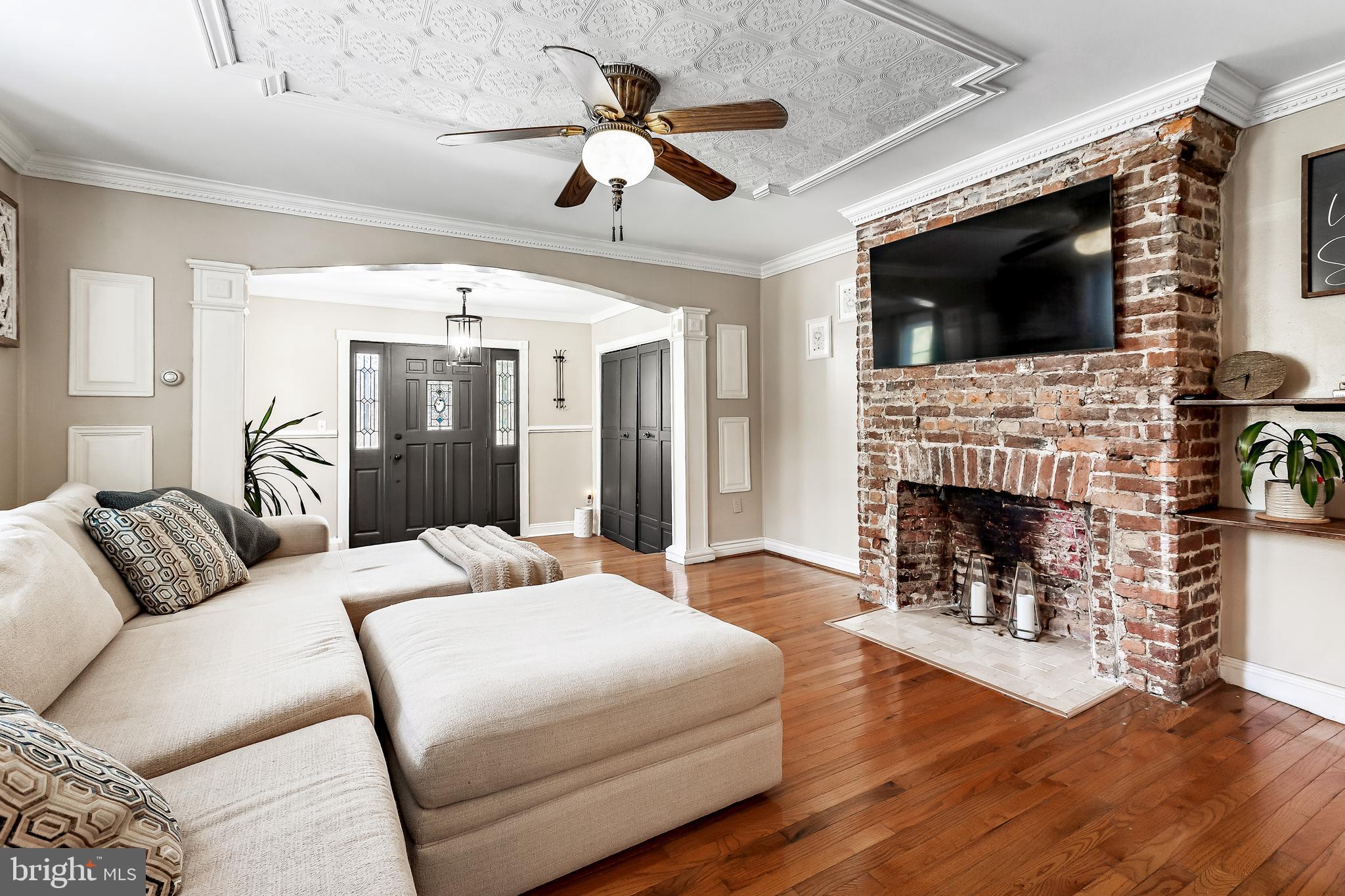 11914 Jericho Road Kingsville, MD 21087 - Photo 15 of 71 a bedroom with a large bed a flat tv screen and a fireplace