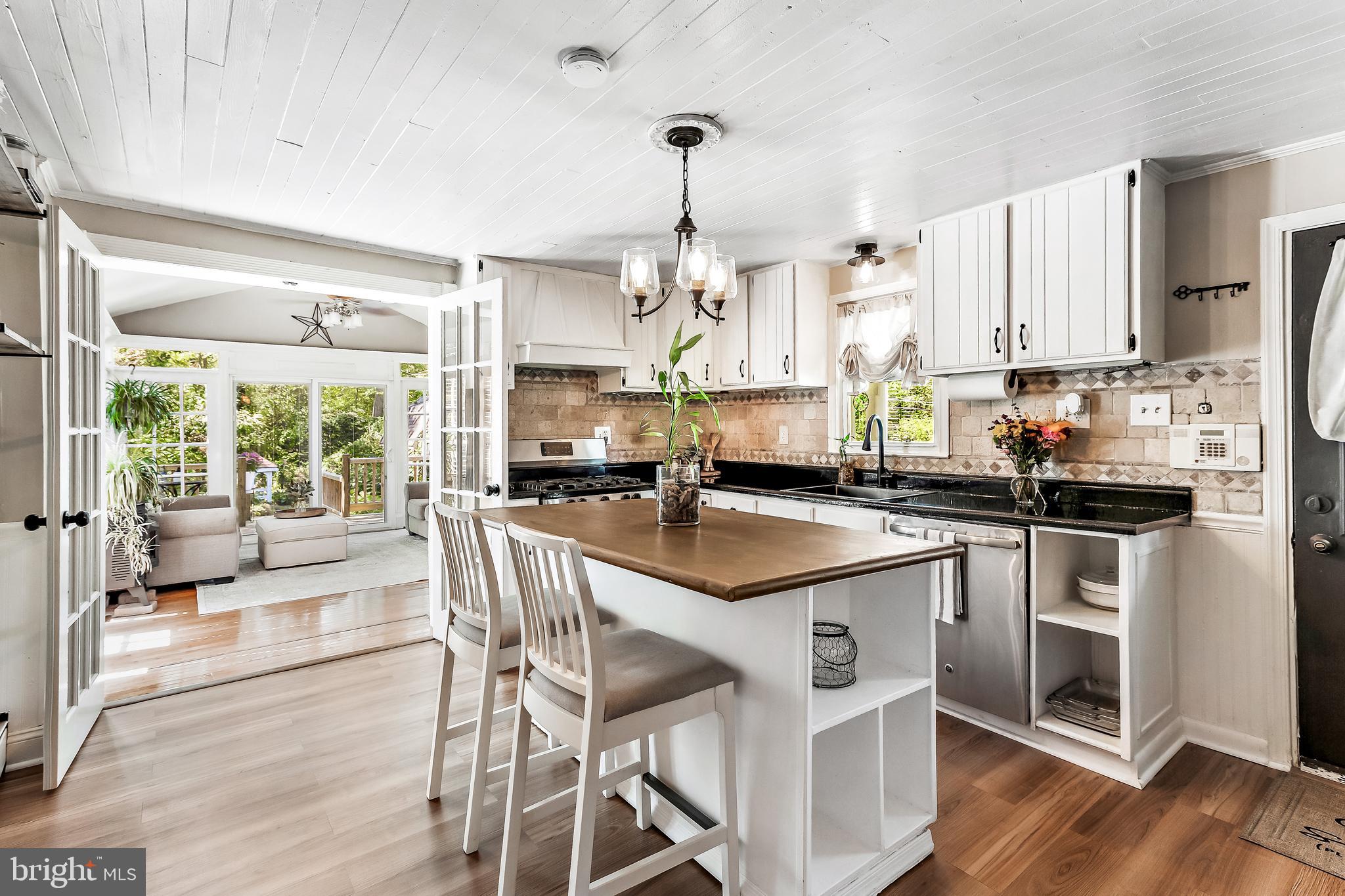 11914 Jericho Road Kingsville, MD 21087 - Photo 2 of 71 a kitchen with stainless steel appliances granite countertop a table chairs stove and white cabinets