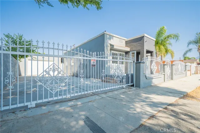 a view of a wrought iron fences in front of house