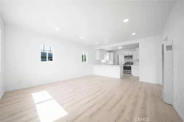 a kitchen with kitchen island a sink stainless steel appliances and cabinets