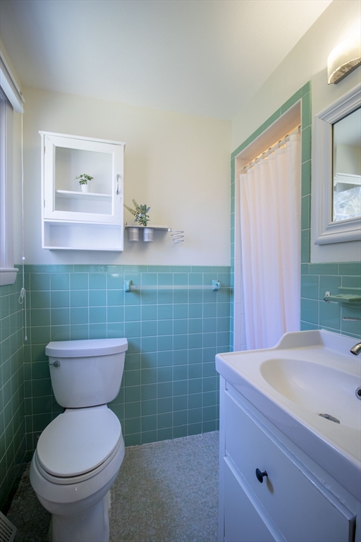 12 Johnson Road Sharon, MA 02067 - Photo 11 of 14 a bathroom with a toilet a sink and mirror