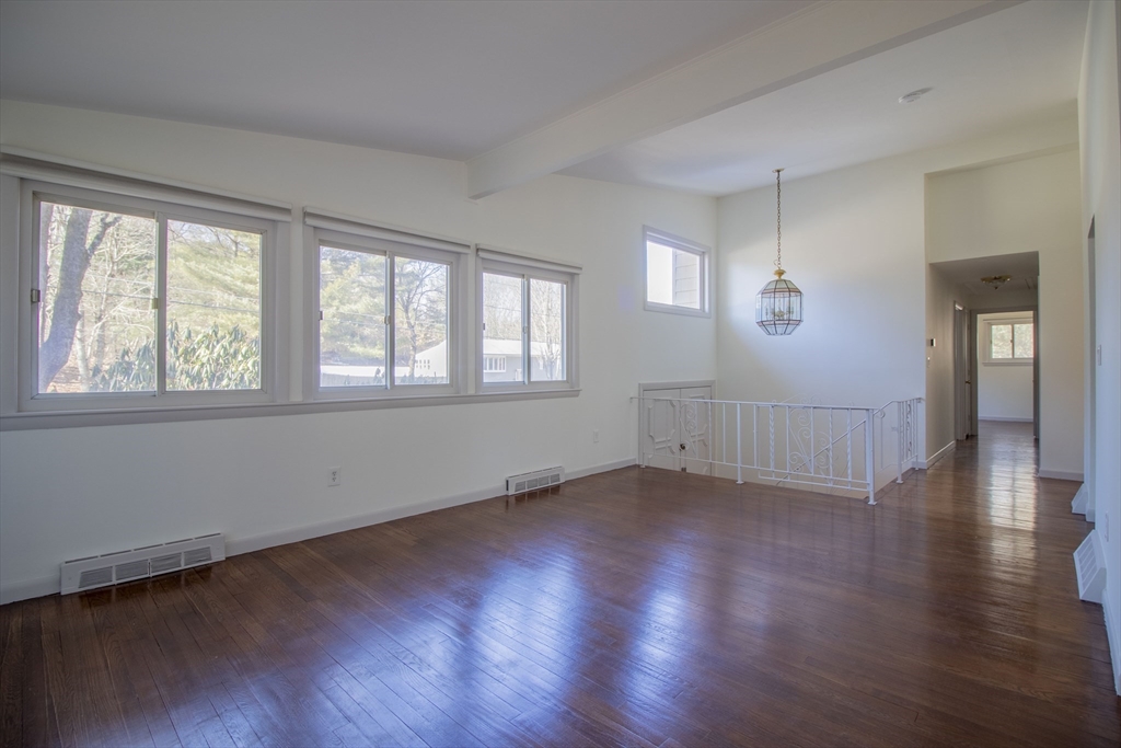 12 Johnson Road Sharon, MA 02067 - Photo 3 of 14 a view of an empty room with wooden floor and a window