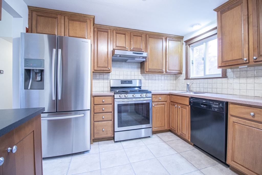 12 Johnson Road Sharon, MA 02067 - Photo 7 of 14 a kitchen with granite countertop stainless steel appliances and cabinets
