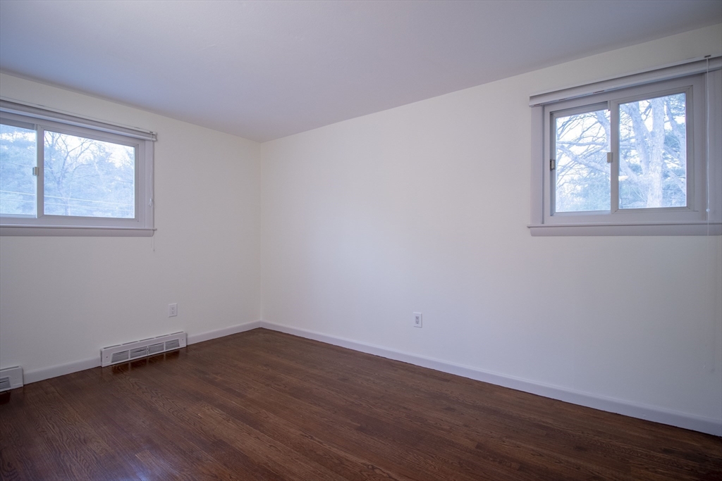 12 Johnson Road Sharon, MA 02067 - Photo 8 of 14 a view of an empty room with wooden floor and a window