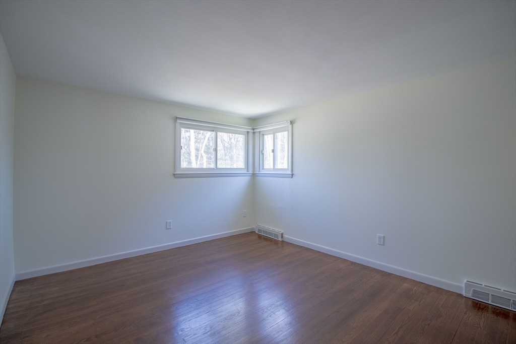 12 Johnson Road Sharon, MA 02067 - Photo 10 of 14 an empty room with wooden floor and windows