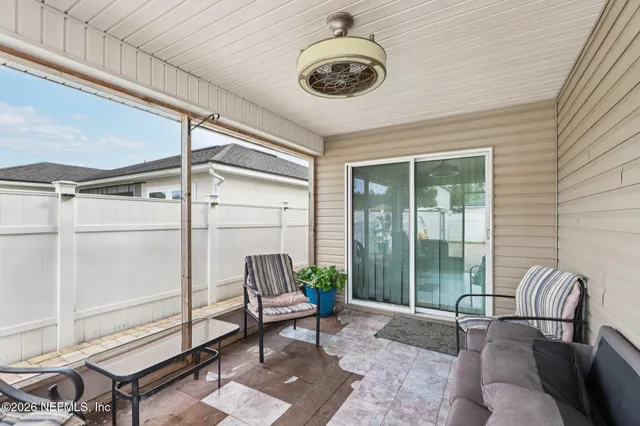 a living room with furniture and a floor to ceiling window