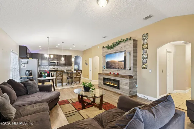 a living room with furniture and a flat screen tv