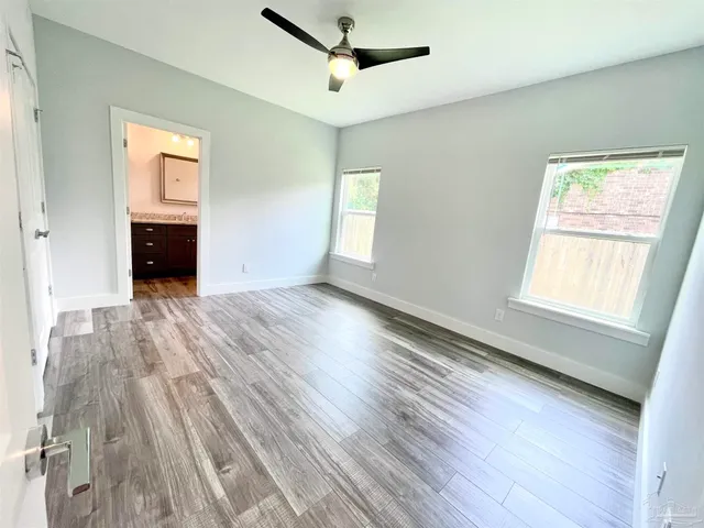 wooden floor in an empty room with a window