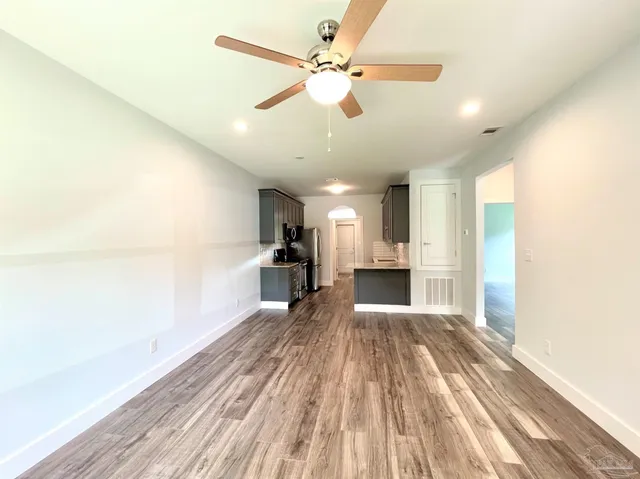 a view of a kitchen with a sink and cabinets