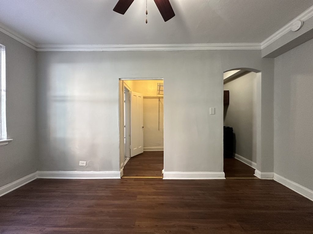 661 West Sheridan Road, Unit 208 Chicago, IL 60613 - Photo 10 of 20 an empty room with wooden floor and closet