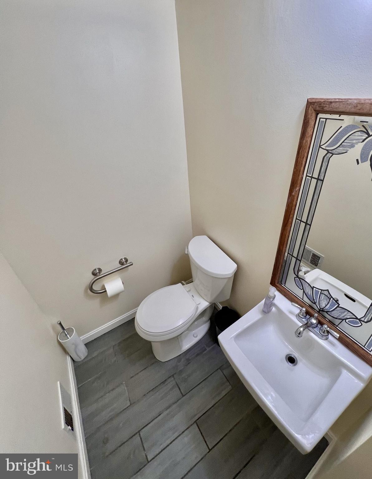 8679 Hickory Ridge Court Springfield, VA 22153 - Photo 12 of 23 a bathroom with a toilet sink and mirror