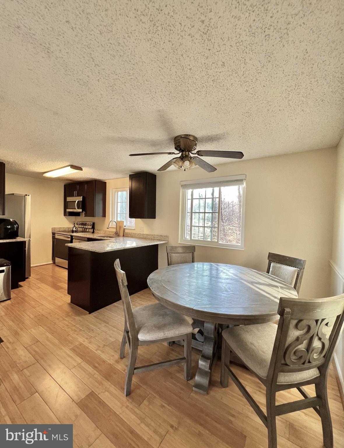 8679 Hickory Ridge Court Springfield, VA 22153 - Photo 3 of 23 a kitchen with a table chairs a sink and appliances