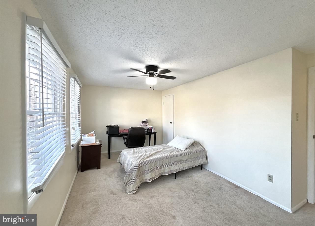 8679 Hickory Ridge Court Springfield, VA 22153 - Photo 7 of 23 a bedroom with a bed and a ceiling fan