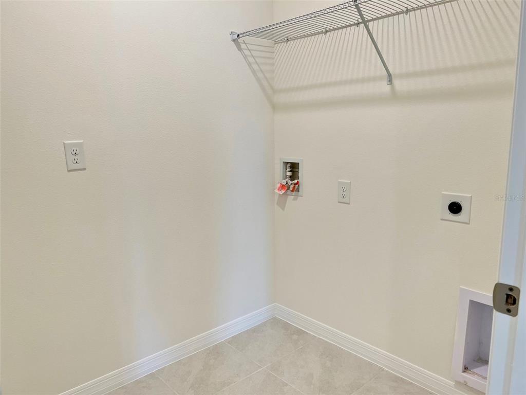 2877 Sunridge Loop St. Cloud, FL 34771 - Photo 17 of 19 a view of small space with racks on the wall