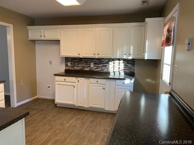 534 Funderburk Road Wingate, NC 28174 - Photo 5 of 11 a kitchen with granite countertop white cabinets and a stainless steel appliances